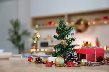 Christmas decorations. A festive table setting with a small tree and holiday gifts.
