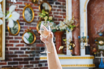 Cheers to celebration with a raised glass in a festive venue