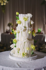Elegant wedding cake decorated with flowers at a reception event