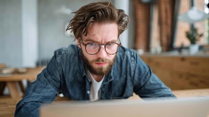 Concentrated Man with Headache Working on Laptop at Home Office - Powered by Adobe