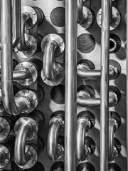 Complex arrangement of shiny metallic pipes and cooler fittings