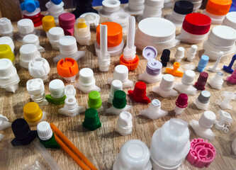 Various colored plastic caps arranged on a table showcasing