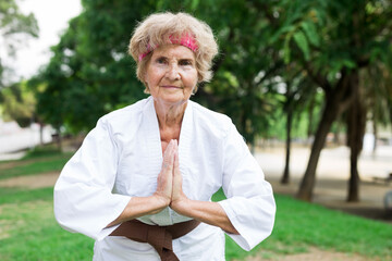 Old woman in kimono training in park