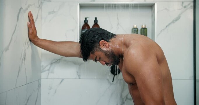 Mental health, thinking or man in shower with reflection, anxiety trigger or memory of past trauma. Grief, flashback or Indian male person in house with sadness, loss or fatigue in emotional thoughts