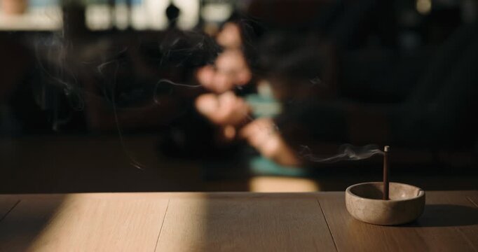 Incense, smoke and meditation in yoga class for peace, mindfulness or holistic wellness. Aroma stick, zen and people with atmosphere for relax, healing or aromatherapy with yogi group on studio floor
