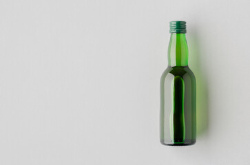 Miniature spirits, liquor bottle mockup, green glass blank copyspace.