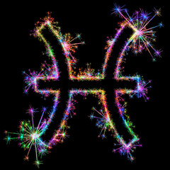 Kolorowe zimne ognie i fajerwerki układające się w kształt znaku zodiaku Ryby. © Blue Pixel