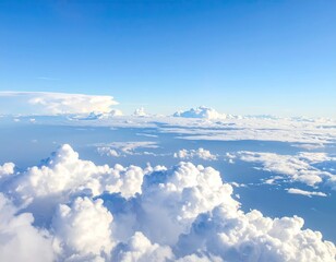 High-altitude view of fluffy white clouds against a vibrant cerulean blue sky.  A vast expanse of clouds stretches across the image, with some appearing dense and others wispy. 
