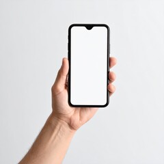 Hand holding a black smartphone with a blank white screen against a plain light gray background