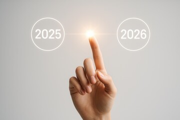 Conceptual representation of choice between years 2025 and 2026 with a focused hand gesture and light glow