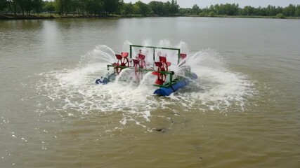 Medium shot capturing the mechanical paddle wheel aerator in action visibly increasing water oxygenation to support fish and aquatic ecosystems.