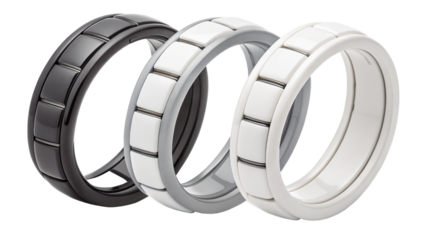 Three silicone wedding rings in black, grey, and white, isolated on transparent background