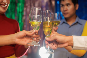 A vibrant festival atmosphere with people drinking and making a toast.