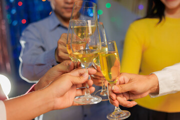 A vibrant festival atmosphere with people drinking and making a toast.