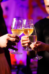 A vibrant festival atmosphere with people drinking and making a toast.