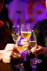 A vibrant festival atmosphere with people drinking and making a toast.