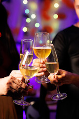 A vibrant festival atmosphere with people drinking and making a toast.