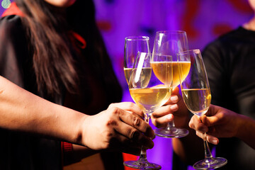 A vibrant festival atmosphere with people drinking and making a toast.