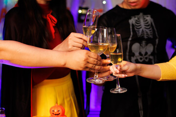 A vibrant festival atmosphere with people drinking and making a toast.