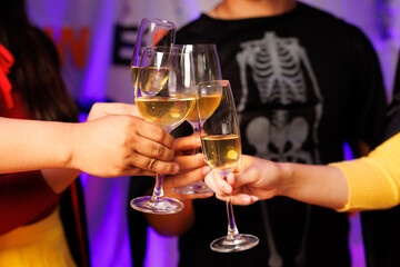 A vibrant festival atmosphere with people drinking and making a toast.
