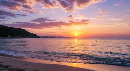 Obraz premium Beautiful sunset over calm ocean waters and a sandy beach landscape