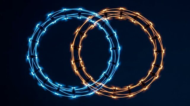 Interlocking illuminated rings glow against a dark background in this abstract artwork.