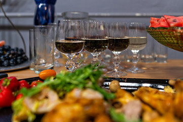Gathering of friends enjoying food and drinks at a festive table setting