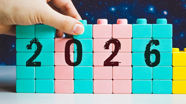 Hand of caucasian woman assembling colorful block toy to form the year 2026. Concept of planning and building bright future. - Powered by Adobe