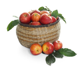 Fresh apples in wicker basket and green leaves isolated on white