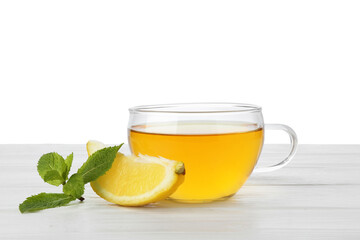 Aromatic tea in cup with lemon and mint on light wooden table against white background