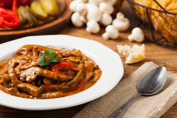Boeuf, Stroganow, Strogonow. Classic, Russian beef stew. Served on a white plate. Front view. Natural background.