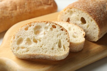 Fresh crispy ciabattas on white table, closeup