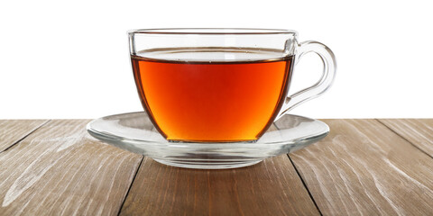 Cup of aromatic black tea on wooden table against white background
