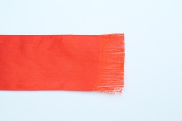 Fototapeta premium Beautiful red ribbon on white background, top view. Space for text