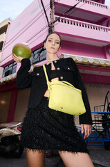 Fashion shoot with a professional model in an Asian city in stylish clothes.