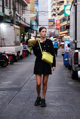 Fashion shoot with a professional model in an Asian city in stylish clothes.