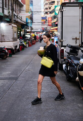 Fashion shoot with a professional model in an Asian city in stylish clothes.