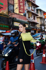 Fashion shoot with a professional model in an Asian city in stylish clothes.