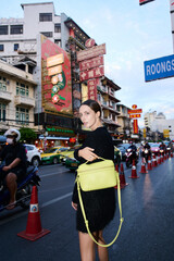 Fashion shoot with a professional model in an Asian city in stylish clothes.