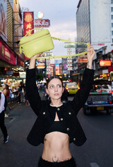 Fashion shoot with a professional model in an Asian city in stylish clothes.