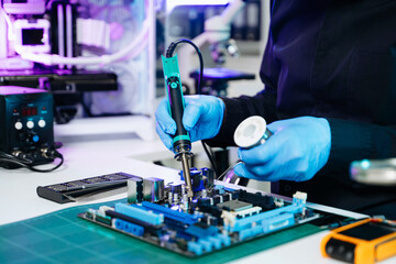 Electronics technician, electronic engineering electronic repair, electronics measuring and testing, repair and maintenance concepts.uses a voltage meter to check and upgrade