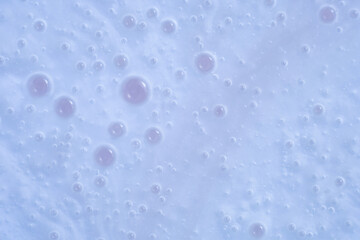 Abstract macro of pastel blue surface densely covered with clusters of pinkish translucent bubbles. The arrangement is soft and dreamy, offering visual interest and copy space