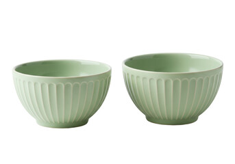 Isolated minimalist set of two light green patterned bowls for food on a clean surface