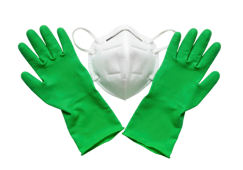 Isolated surgical mask with two green gloves, safety measures for hygiene and protection