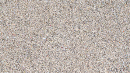 Close-up photo of natural sand creating a textured background. The image shows fine grains and soft natural color, ideal for backgrounds, design projects, web graphics, and nature concepts. Perfect