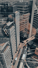Fototapeta premium Aerial view of modern city skyline with tall skyscrapers in sunlight.