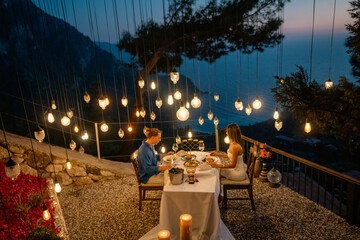 Romantic vacation moment as a couple enjoys sunset dinner