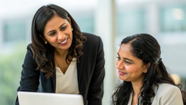 Indian businesswoman providing encouragement to colleague — showcasing mentorship, support, and teamwork