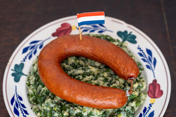 Traditional Dutch Dish Stamppot Boerenkool met Worst, Mashed Potatoes with Kale, Smoked Sausage, and Gravy