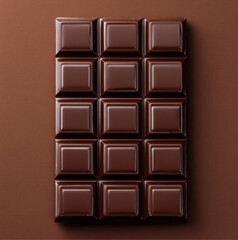 Fototapeta premium A top-down shot of a premium chocolate bar, fully visible in frame, The chocolate has a rich brown color with slight reflections, highlighting its creamy texture.